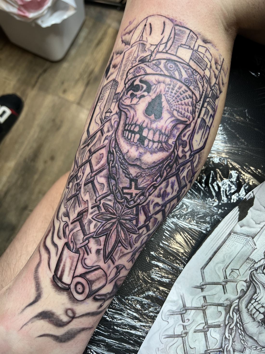 Tattoo: Black & grey realism — Chicano skull and city